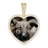The Heart Picture Pendant in 10k Solid Gold displays a heart-shaped gold pendant outlined with small white gems, featuring a close-up photo of a light brown dog with blue eyes at its center.