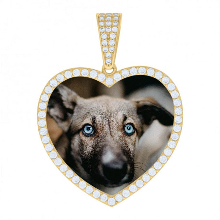 The Heart Picture Pendant in 10k Solid Gold displays a heart-shaped gold pendant outlined with small white gems, featuring a close-up photo of a light brown dog with blue eyes at its center.