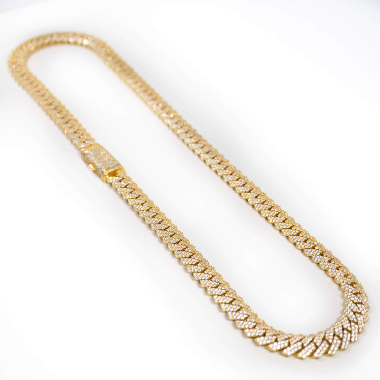 The Moissanite Cuban Link Chain 8mm-23mm in solid yellow gold, featuring sparkling moissanite stones, is displayed on a white background.