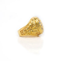 The Round Cluster Ring in Solid Gold features intricate engraved patterns on the band and a cluster of small round stones on top, showcased against a white background.