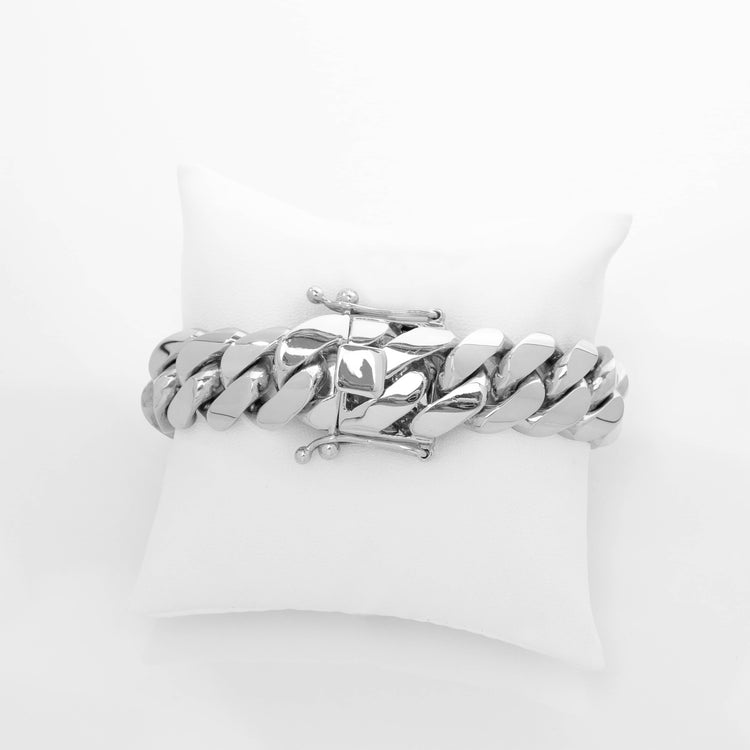 The 18mm Handmade Miami Cuban Link Bracelet in solid 950 silver with a clasp is shown on a small white cushion against a plain white background.