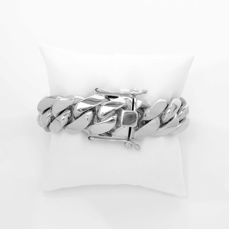 The 20mm Handmade Miami Cuban Link Bracelet in 950 Silver features a bold, chunky rectangular clasp and is displayed on a white pillow—an eye-catching handmade silver statement piece for your wrist.