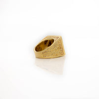 The Square Cluster Ring in Solid Gold features intricate engraved side patterns and is displayed on a white reflective surface, making it a stunning piece of gold jewelry.