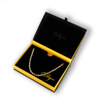 The Tricolor Milano Figarope - 4.5mm 14K Solid Gold chain necklace is presented in an open black and yellow box with "Goldzum" on the lid and bottom, highlighting its exquisite Italian craftsmanship.