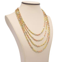 The Tricolor Milano Figarope - 4.5mm 14k Solid Gold necklace features twisted yellow, rose, and white gold links that highlight Italian craftsmanship, elegantly presented on a cream jewelry bust.