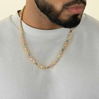A man with a trimmed beard wears a light gray crewneck and the Tricolor Milano Figarope 4.5mm necklace in 14k solid gold, featuring Italian craftsmanship in yellow, white, and rose gold. Only his lower face, neck, and upper chest are visible.