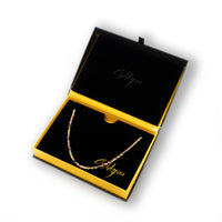 The Tricolor Milano Figarope Chain - 3.5mm 14k Solid Gold is shown in an open black and yellow box, featuring "Goldzeni" in gold lettering on the inside lid and base.