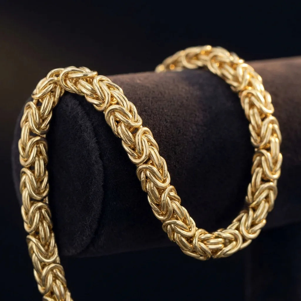 Close-up of a solid gold Byzantine chain showing the intricate interlocking 4-in-1 weave pattern handcrafted by GOLDZENN