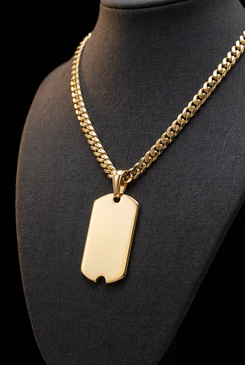 14K solid gold military dog tag pendant with Cuban link chain on dark display bust