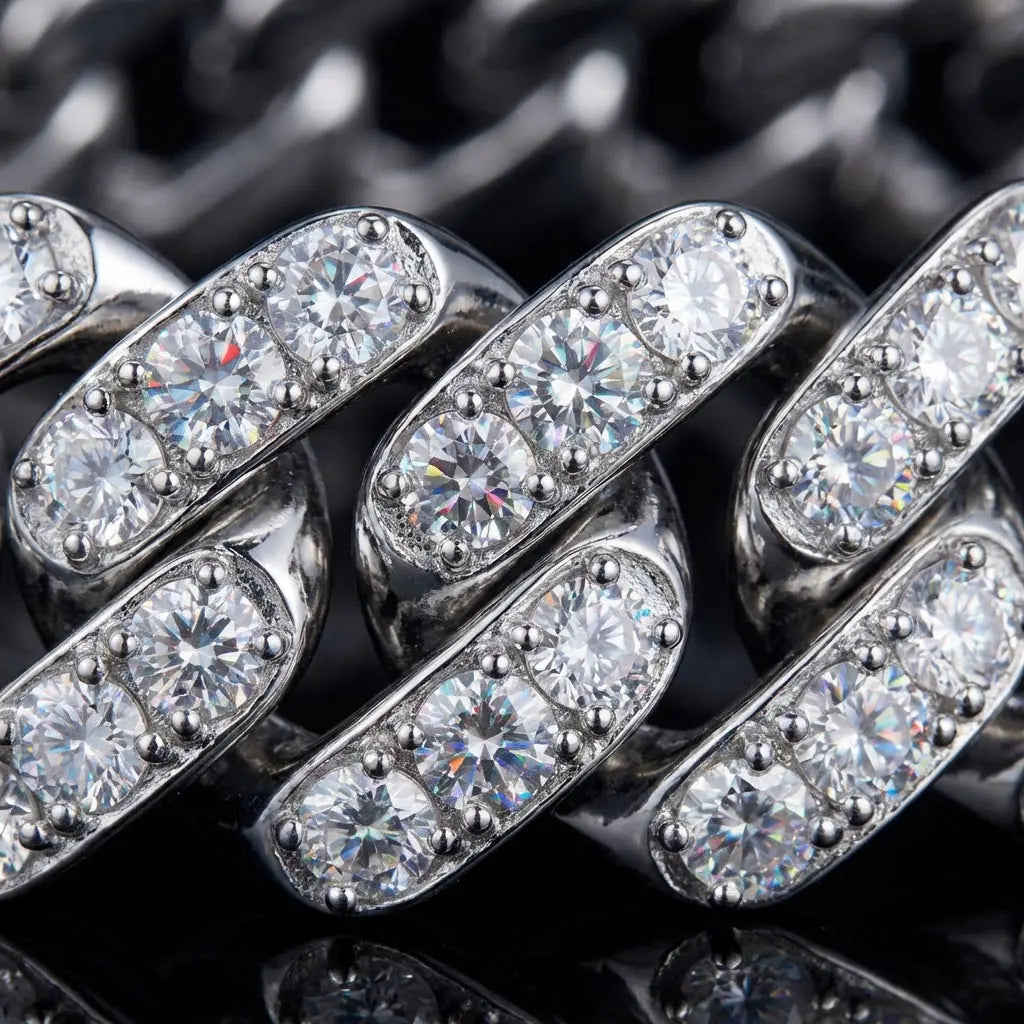 Extreme macro close-up of moissanite stones prong-set between interlocking sterling silver Cuban links, showing individual prongs securing each stone with dramatic lighting revealing fire and brilliance