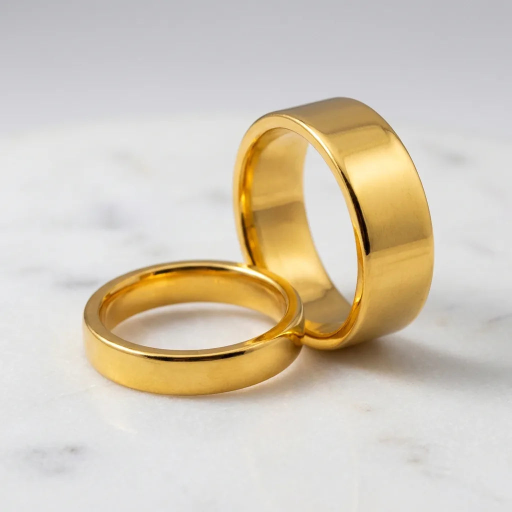 24K gold wedding band pair showing his and hers bands in pure gold