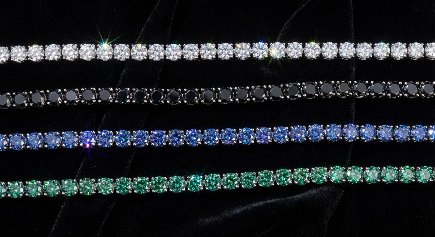 Four moissanite tennis chains in different colors on dark velvet: clear white, black, blue, and green moissanite stones in sterling silver settings showing each color's distinct light properties